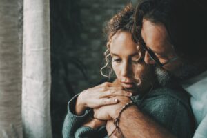 Couple hugging in an article asking if sex therapy can help you.