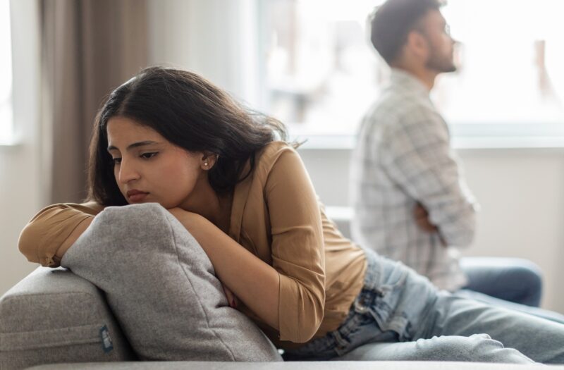 Couple struggle and not looking at one another in an article by Stefanie Kuhn, LMFT on how to forgive yourself for cheating.