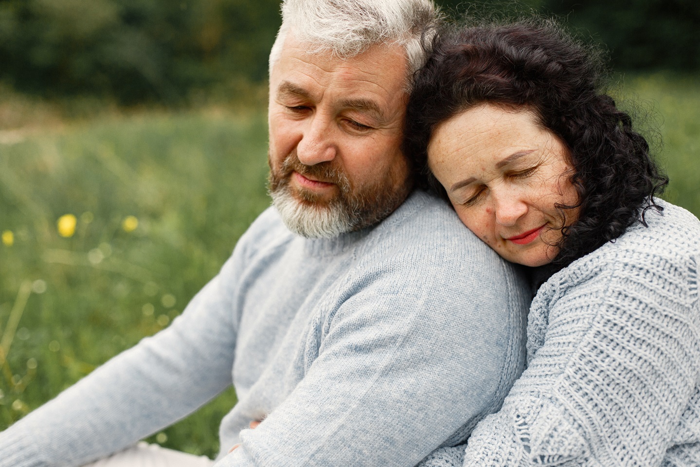 Couple hugging in an article on how to rebuild trust after cheating by Stefanie Kuhn, MA.