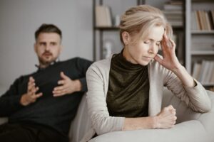 Unhappy couple in an article on why couples stop having sex by Therapy Works Well.