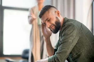Man having awful headache while having psychological investigation