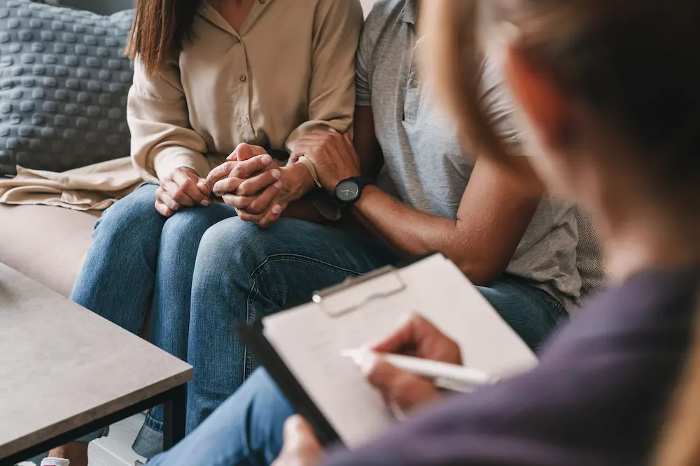 Therapy that Works with Stefanie Kuhn | TherapyWorks: Texas Couple holding hands during counseling at an intensive marriage retreat.
