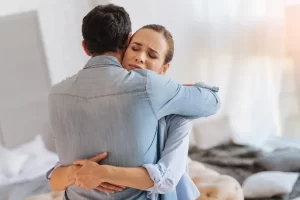 Couple embracing during an emotional moment illustrating healing and rebuilding trust after infidelity