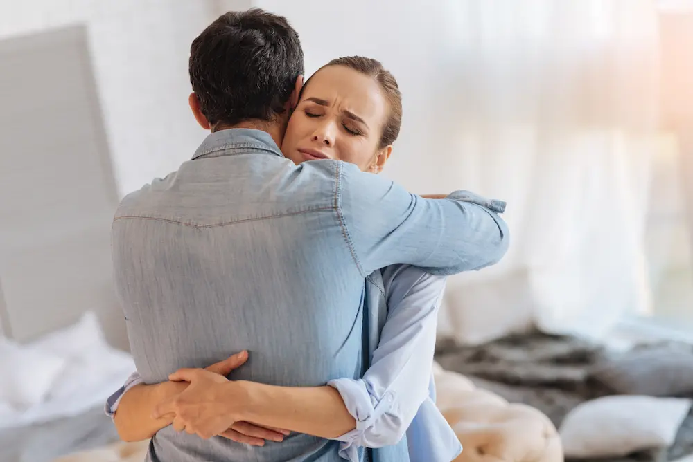 Couple embracing during an emotional moment illustrating healing and rebuilding trust after infidelity